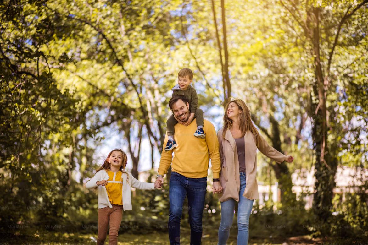 A family walking together in a sunny park